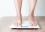 Person standing on a bathroom scale